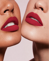 Close-up shot of two models with different skin tones wearing Swiss Miss Silk Lipstick in shade Ruby Pink (717).