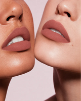 Close-up shot of two models with different skin tones wearing Swiss Miss Silk Lipstick in shade So Plum (720).