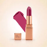 Swiss Miss Silk Lipstick in shade Spring Lilac (722) in gold bullet packaging shown alongside a textured cream color swatch.