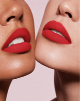 Close-up shot of two models with different skin tones wearing Swiss Miss Silk Lipstick in shade Tangerine (728).