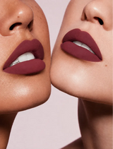 Close-up shot of two models with different skin tones wearing Swiss Miss Silk Lipstick in shade Viva Heart (725).