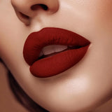 Close-up of lips wearing Swiss Miss The Signature Muse B-115 matte red lipstick shade.