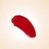 Bold crimson red texture swatch of Swiss Miss Velvet Sin B-110 lipstick on a neutral background.