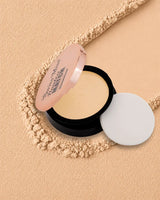 Swiss Miss Flawless Match Compact Powder open case with sponge applicator in shade Fine Ivory SM 02 over a textured powder background