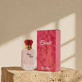 Swiss Miss Elante Perfume 15ml bottle with red diamond cap next to pink geometric box on a stone pedestal