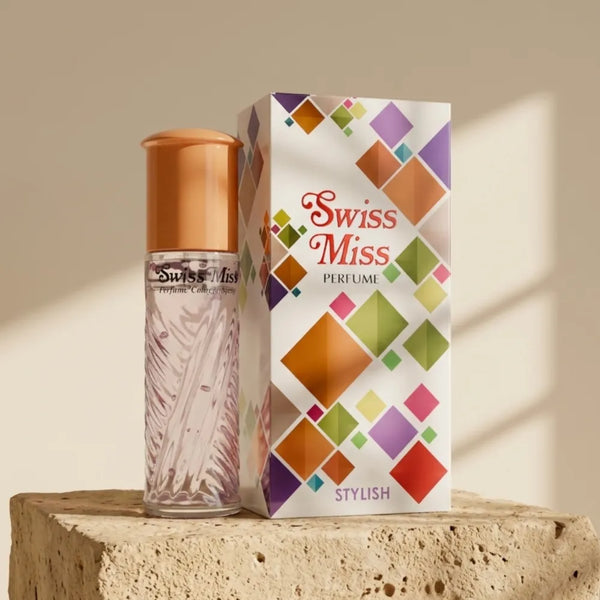 Swiss Miss Stylish Perfume 15ml textured glass bottle with gold cap next to colourful geometric box on a stone pedestal